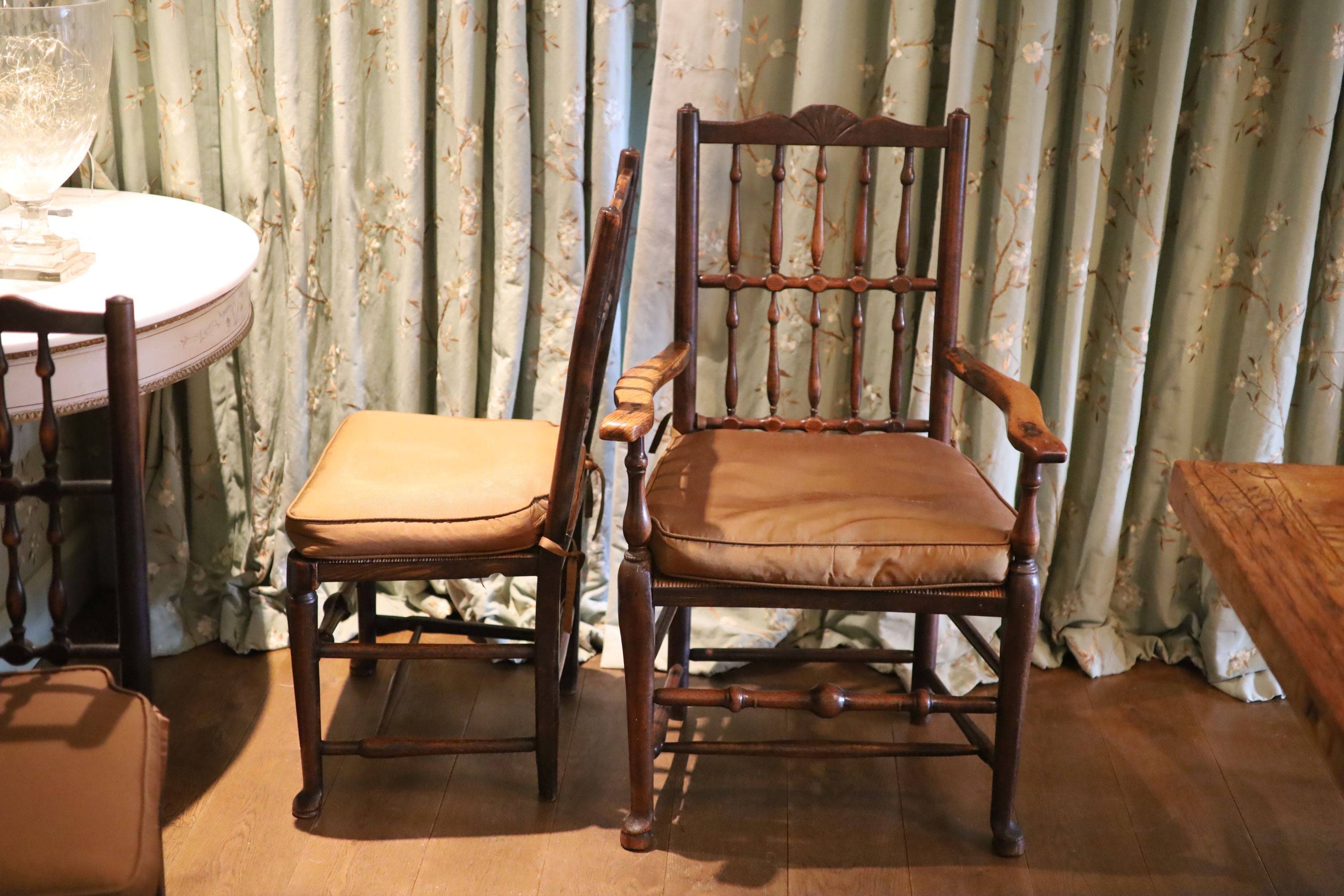 A harlequin set of twelve 19th century Derbyshire spindle back dining chairs, including two carvers, with rush seats and pad feet, height 93cm largest carver 115cm